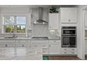 Bright and airy kitchen featuring stainless steel appliances, white cabinets and granite countertops at 403 Hidden Meadow Ln, Summerville, SC 29486