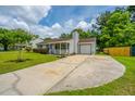 View of a well maintained single-story home featuring a long driveway leading to a garage at 505 Laurel Ridge Rd, North Charleston, SC 29418