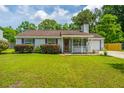 Attractive single-story home featuring a cozy front porch, gray siding, and a well-kept lawn at 505 Laurel Ridge Rd, North Charleston, SC 29418