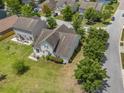 This aerial shot captures the home's backyard, landscaping, and proximity to other houses in the neighborhood at 5400 Turning Tide, North Charleston, SC 29420