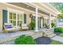 Inviting front porch with comfortable seating and manicured landscaping at 5692 Barbary Coast Rd, Hollywood, SC 29449