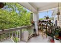 Outdoor balcony with plants, seating, and a view of the surrounding greenery at 60 Fenwick # 936, Johns Island, SC 29455