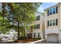 Two-story residential building exterior with neutral siding, black shutters and trees at 60 Fenwick # 936, Johns Island, SC 29455
