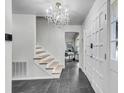 Bright foyer with tile flooring, a chandelier and an open staircase leading to the upper level at 615 Fairington Dr, Summerville, SC 29485