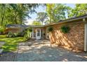 A stone patio connecting the house to the yard with lush greenery and ample space for outdoor activities at 620 Clearview Dr, Charleston, SC 29412