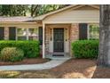 Close-up of the front door with brick facade and neatly trimmed hedges at 620 Clearview Dr, Charleston, SC 29412