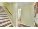 Inviting hallway with hardwood floors, staircase, and view into adjacent room at 710 S Magnolia St, Summerville, SC 29483