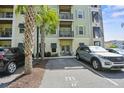 Multi-level condo building with reserved parking and palm trees accenting the facade at 7101 Bowen Corner Ave, Hanahan, SC 29410