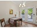 Bright dining area with hardwood floors, french doors, and stylish chandelier lighting at 7101 Bowen Corner Ave, Hanahan, SC 29410