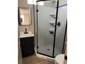 Modern bathroom featuring a glass enclosed shower, vanity, and mirror at 78 Hannibal Trl, Ridgeville, SC 29472