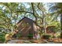 Cozy home surrounded by towering trees and lush foliage, offering privacy and a serene setting at 810 Creekside Dr, Mount Pleasant, SC 29464