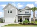 Charming two-story home with a well-manicured lawn and integrated two car garage at 102 Bolsena Ct, Summerville, SC 29486