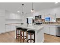 Bright kitchen with white cabinets, stainless steel appliances, a brick backsplash, and hardwood floors at 105 Evatt Dr, Goose Creek, SC 29445
