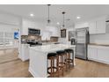 Modern kitchen features a center island with seating, stainless steel appliances, and brick backsplash at 105 Evatt Dr, Goose Creek, SC 29445