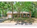 Traditional brick home with a single car garage, mature trees and a well-kept lawn at 106 Kent Cir, Ladson, SC 29456