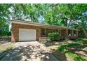 A single-story brick home with an attached garage and a well-maintained lawn at 106 Kent Cir, Ladson, SC 29456
