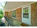 Inviting front porch with brick facade, and a welcoming 'Welcome' mat at 106 Kent Cir, Ladson, SC 29456