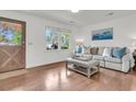 Bright and airy living room with hardwood floors, stylish furniture, and natural light streaming through the window at 108 Williamsburg Ct, Goose Creek, SC 29445