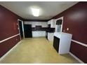 The kitchen is spacious, with white cabinetry and black appliances against red walls at 1110 Pickett St, Moncks Corner, SC 29461