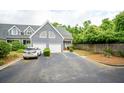 Charming townhome featuring a two-car garage, manicured landscaping, and inviting curb appeal at 112 Waterfront Plantation Dr, Charleston, SC 29412