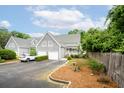 Beautiful townhome showcasing a two-car garage, lovely landscaping, and a well-maintained exterior at 112 Waterfront Plantation Dr, Charleston, SC 29412