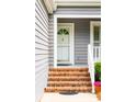 Inviting front entrance with brick steps and a classic white door, providing a warm welcome at 112 Waterfront Plantation Dr, Charleston, SC 29412
