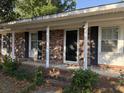 Inviting brick front porch with black door and white columns at 1138 Landsdowne Dr, Charleston, SC 29412
