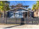 Charming two-story home with a fenced-in yard and mature landscaping at 1153 King St, Charleston, SC 29403