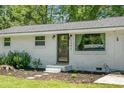 The home's front door is accessible from a garden path with meticulous landscaping at 1192 Church Of God Rd, Bonneau, SC 29431