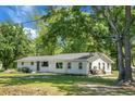 Classic single-story home featuring a well-maintained lawn and large, mature trees at 1192 Church Of God Rd, Bonneau, SC 29431