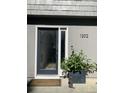 Front door of a gray home with black trim, modern house numbers, and greenery at 1202 Ventura Pl, Mount Pleasant, SC 29464
