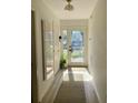 Bright hallway with a decorative mirror, a gray rug, and a glass-paneled front door at 1202 Ventura Pl, Mount Pleasant, SC 29464