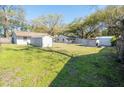A view of a large backyard with green grass and a variety of storage sheds at 1230 Hawthorne Cir, Hanahan, SC 29410