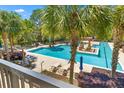 Relaxing pool area featuring lounge chairs and palm trees for a resort-style experience at 125 Pier View St # 405, Daniel Island, SC 29492
