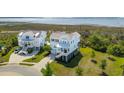 An elevated view of the property showing the beautiful light blue home near a marsh at 1502 Menhaden Ln, Mount Pleasant, SC 29466