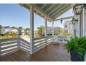 Inviting front porch with wood flooring, white railings, and comfortable seating, perfect for relaxing outdoors at 1502 Menhaden Ln, Mount Pleasant, SC 29466