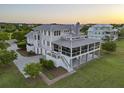 Expansive waterfront home with wraparound porch, generous lot, and immaculate landscaping at 1518 Bower Ln, Johns Island, SC 29455