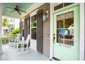 Charming front porch with rocking chairs and a light green front door, creating a cozy entrance at 1629 Ware Bottom Ln, Mount Pleasant, SC 29464