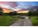 Scenic backyard view with a boat launch leading to a tranquil waterway at 1673 Mcclain St, Charleston, SC 29407