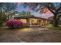 Beautiful brick home featuring a welcoming porch and lush landscaping at 1673 Mcclain St, Charleston, SC 29407