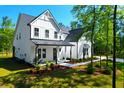 Charming two-story home with a modern farmhouse design and meticulously landscaped front yard at 202 Countryside Way, Summerville, SC 29483