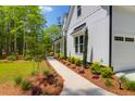 Close up view of an impressive two-story home with a well-maintained lawn and lovely landscaping at 202 Countryside Way, Summerville, SC 29483