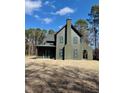 A two-story home with a chimney and a covered entry way under a blue sky at 2151 River Road, Johns Island, SC 29455