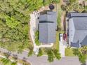Aerial view of the house, showcasing its roof, driveway, backyard with trampoline, and proximity to neighboring houses at 2197 Sandy Point Ln, Mount Pleasant, SC 29466