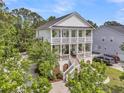 Stately two-story home with dual covered porches and steps leading to the entrance at 2197 Sandy Point Ln, Mount Pleasant, SC 29466