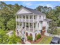 Gorgeous home with double decks overlooking a lush yard, landscaping, and fencing at 2197 Sandy Point Ln, Mount Pleasant, SC 29466