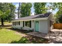 Charming one-story home with a teal door, black shutters, and green grass at 2219 Eagle Dr, North Charleston, SC 29406
