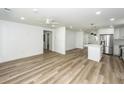Open floor plan living room with light wood floors and a ceiling fan at 2219 Eagle Dr, North Charleston, SC 29406