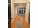 Bright foyer leads into living room with large windows, fireplace and hardwood floors at 255 Oak Point Landing Dr, Mount Pleasant, SC 29464