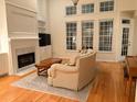 Light and airy living room showcases a fireplace, hardwood floors, and a comfortable couch at 255 Oak Point Landing Dr, Mount Pleasant, SC 29464